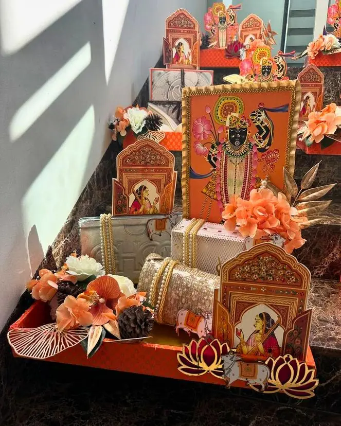 Shrinathji-themed hamper in orange with lotuses