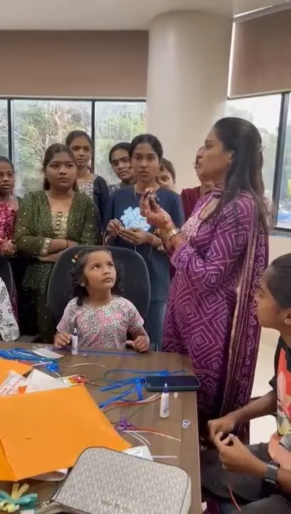 Kids and adults gathered around a candle workshop
